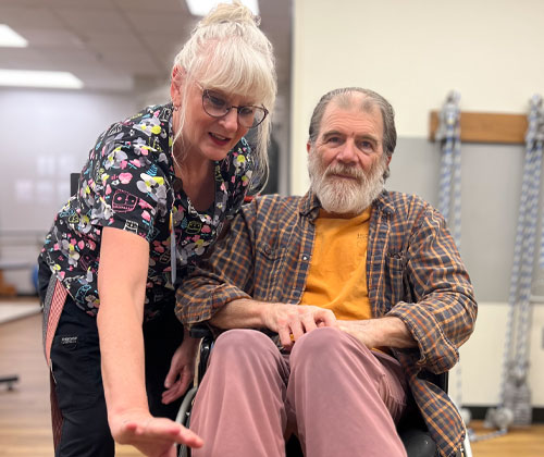 Nurse-helping-an-elderly-man-in-a-wheelchair